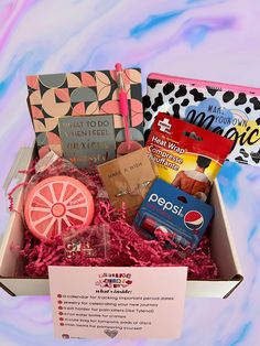 a box filled with lots of different items on top of a blue and pink background