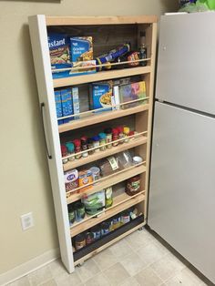 a refrigerator freezer sitting inside of a kitchen next to a counter with food on it