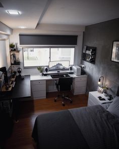 a bedroom with a bed, desk and window