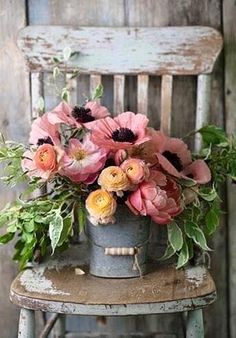 a happy friday card with flowers in a bucket on an old chair and the words, happy friday