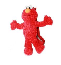 a red stuffed animal with one eye on it's face and arms out, standing upright