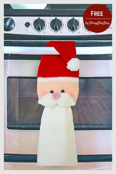 a knitted santa claus hat hanging from the side of an oven with free crochet pattern