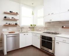 a kitchen with white cabinets and stainless steel dishwasher, stove top oven and sink