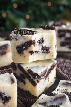 several pieces of oreo cake sitting on top of each other in front of a christmas tree