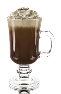 a glass mug filled with liquid on top of a table