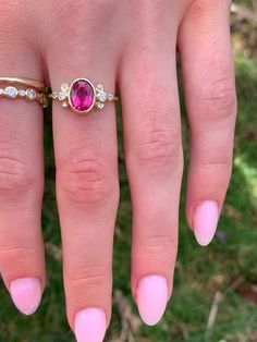 A vibrant Pink tourmaline is set in Emily's 14k gold Trefoil cluster setting with a freeform band. We originally saw this as being a unique engagement ring but it would be just as wonderful as an everyday bit of sparkle and looks phenomenal with our halo bands Approximate stone size: 9mm x 7mm TCW tourmaline: 1.2ct TCW diamonds: .12ct Mohs Stone Hardness: 7.5-8 This one of a kind piece is handmade with love in Emily's Hudson Valley studio. If you have questions about sizing, shipping or need hel Yellow Gold Tourmaline Rings With Rose Cut Diamonds, Unique Oval Ruby Ring With Rose Cut Diamonds, Yellow Gold Ruby Ring With Tourmaline Center Stone, Fine Jewelry Rings With Rose Cut Diamonds And Tourmaline, Tourmaline Rings With Rose Cut Diamonds For Anniversary, Pink Tourmaline Engagement Ring, Halo Band, Green Tourmaline Ring, Pink Tourmaline Ring