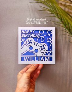 someone holding up a birthday card that says happy birthday william with a video game controller on it