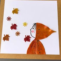 a card with leaves and a child's face made out of paper on it