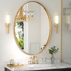 a bathroom vanity with a large round mirror above it and two lights on the wall