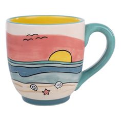 a ceramic mug with an ocean scene painted on it's side and stars in the sky