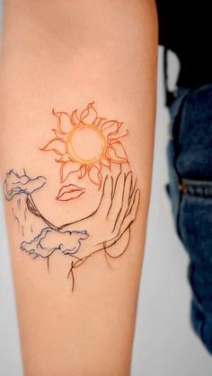 a woman's arm with a sun and hands tattoo on the left side of her body