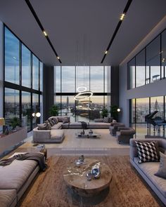 a living room filled with lots of furniture and large windows overlooking the cityscape