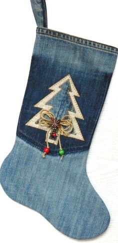 a christmas stocking made out of blue jeans with a bow and bells on it