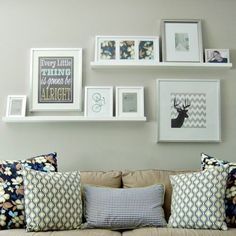 a living room filled with lots of furniture and pictures on the wall above it's coffee table