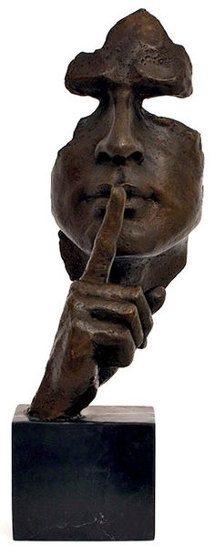 a bronze sculpture of a man holding his finger up to his mouth with both hands