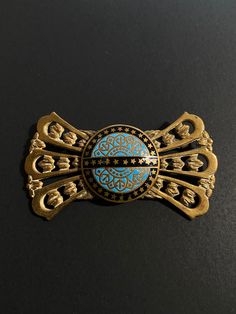 A very nice example of Antique / vintage jewellery.  A French enamel brooch,  with push pull trombone clasp, gilt bronze brooch, blue enamelled decoration. The metal looks like gold but I believe is gilt bronze as I cannot find any hallmarks. Enamel was used on pieces from Limoges? There is a possibility it is from that area of France ?  It has a "push pull clasp" also known as a trombone clasp.  Good vintage or antique condition but please see photos as will naturally have signs of wear and age Gold Enamel Art Nouveau Brooches, Gold Enamel Lapel Pin, Gold Enamel Brooch Pin, Collectible Gold Enamel Pins, Antique Gold Enamel Pin, Antique Blue Collectible Brooches, Vintage Blue Brooch Pin, Formal Blue Enamel Brooches, Vintage Gold Enamel Lapel Pin