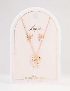 Charm with this gold bow necklace and earring set. Perfect as a thoughtful gift, the delicate bows and gleaming gold for adding understated luxury to any outfit. Shine brightly, whether you're dressing up or down. Dimensions: Chain Length: 45 cm Earring Length 9 mm x Earring Width 9 mm Extender: 8 cm Feature Dimensions: Pendant Width 15 mm x Pendant Height 15 mm | Lovisa Gold Bows Necklace & Earring Set Cheap Gold Charm Necklaces For Bridesmaids, Bow Necklace, Understated Luxury, Necklace And Earring Set, Necklace Earring Set, Chain Lengths, Chain Length, Earring Set, Thoughtful Gifts