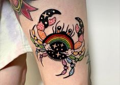 a colorful crab tattoo on the leg