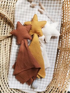 three star shaped pillows sitting on top of a wicker basket