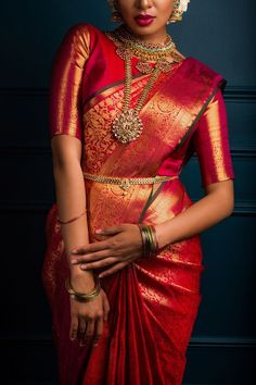 a woman in a red and gold sari