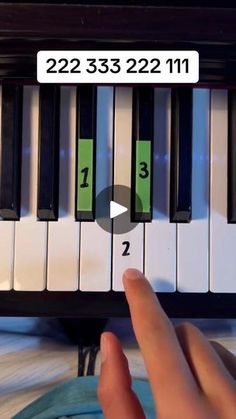 someone is playing the piano with their fingers and thumbnails on it's keyboard