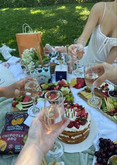 people sitting at a table with food and drinks