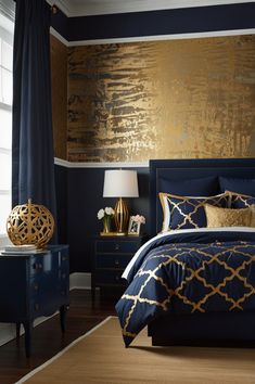 a bedroom decorated in blue and gold colors