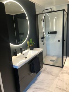 a bathroom with a sink, mirror and shower in it's center area is shown