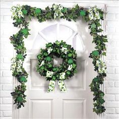 a white door with a green wreath hanging on it