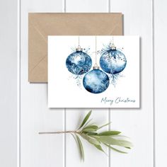 a card with three blue ornaments hanging from it