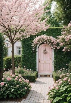 a pink door surrounded by flowers and trees