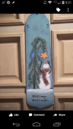 a skateboard painted with a snowman holding a star