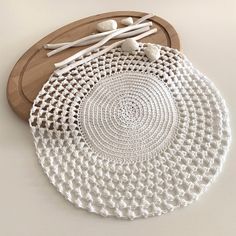 a white crocheted doily on a wooden tray