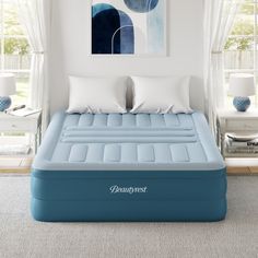 an inflatable bed with two pillows on top and the mattress is made up