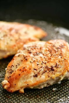 two pieces of cooked chicken in a frying pan