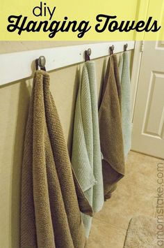 towels hanging on the wall with text overlay that says diy hagging towels