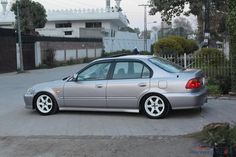 a silver car is parked on the street