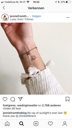 a person's wrist with a small tattoo on the left side of their arm