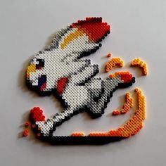 a piece of art made out of legos and some sort of animal with an orange tail