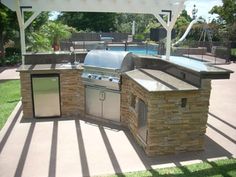 an outdoor bbq with grill and sink