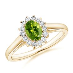 The design of this beautiful peridot ring is inspired by Princess Diana's unrivalled style statement and her beautiful engagement ring. A radiating oval peridot sits majestically at the core while the dazzling diamonds accentuate its beauty. The diamonds in a prong setting, form a scintillating floral halo around the chartreuse green gemstone. Sculpted in 14k yellow gold, this peridot and diamond ring bespeaks glamour and elegance. Floral Halo, Green Oval, Contemporary Ring, Ring With Diamond, Beautiful Engagement Rings, Peridot Ring, Halo Diamond Ring, August Birth Stone, Green Gemstones