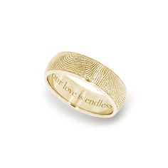 a fingerprint ring with the words, out for it's endlessness in gold