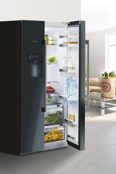 an open refrigerator with its door wide open and filled with fresh fruits and veggies