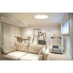 a living room filled with furniture next to a window