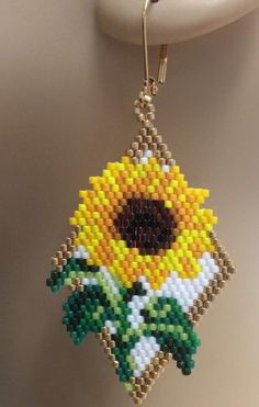 a beaded sunflower hanging from a hook