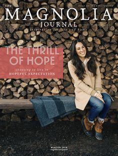 the cover of magnolia journal featuring a woman sitting on a bench in front of stacked logs