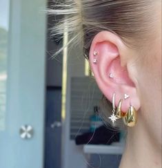 a close up of a person with ear piercings