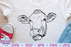 a t - shirt with a cow's face drawn on it