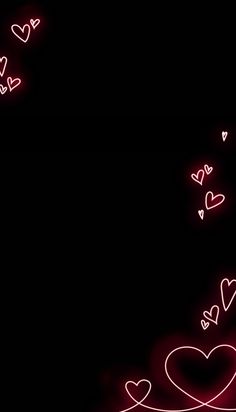 two hearts are glowing in the dark with pink lights on them and white swirls