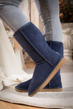 Stay warm in chic, eye-catching style when you pull on these most classic mid length style that features genuine suede leather and a plush faux fur-lining keep your feet warm. 1'' heel 11.5'' shaft 15.8'' circumference Pull-on Suede upper Faux fur lining Man-made EVA sole Navy Blue Ugg Boots, Blue Ugg Boots, Womens Summer Jumpsuits, Stylish People, Ugg Style, Navy Shoes, Black Leather Sandals, Ugg Classic, Eva Sole